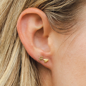 woman wearing gold bee earrings
