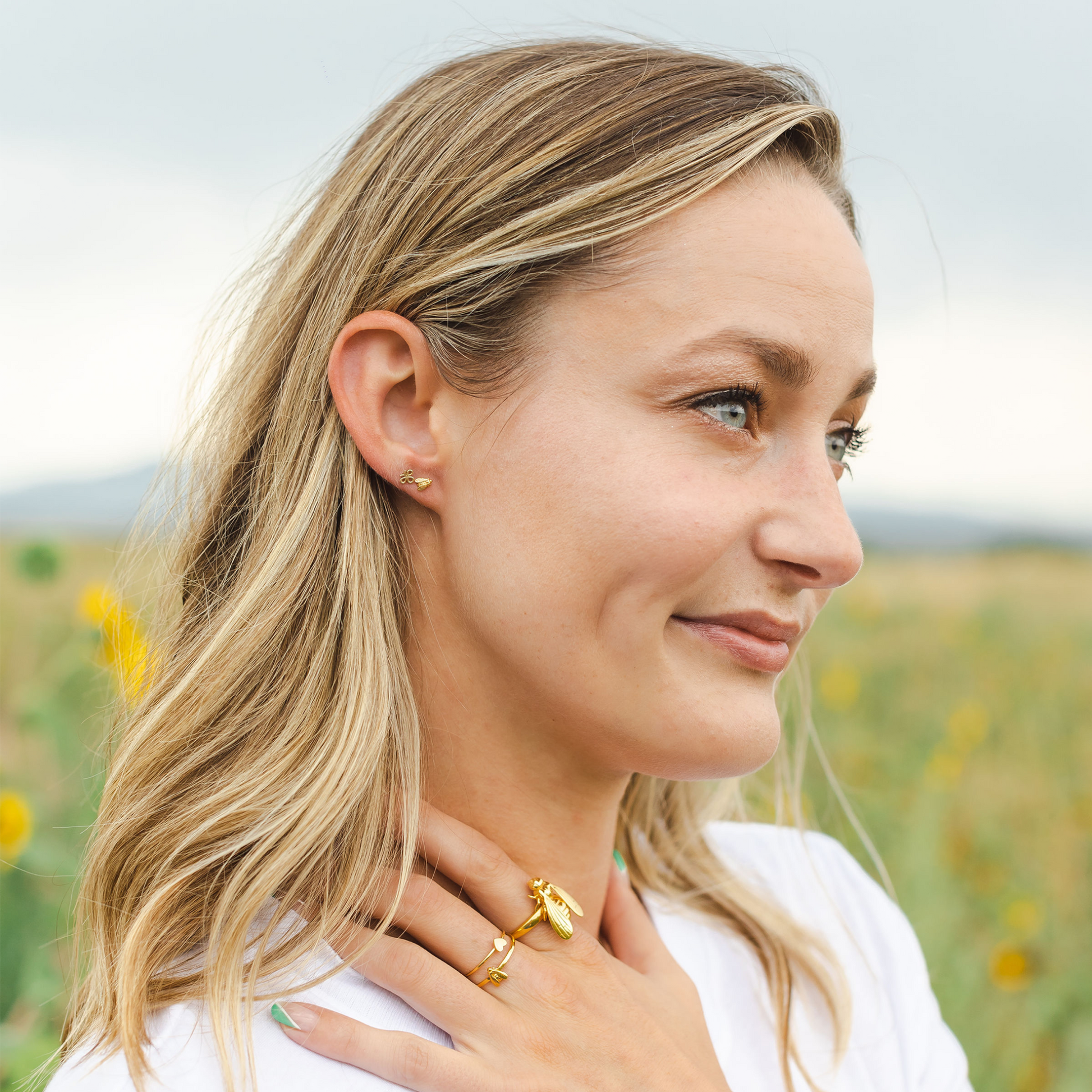 woman wearing gold bee earrings