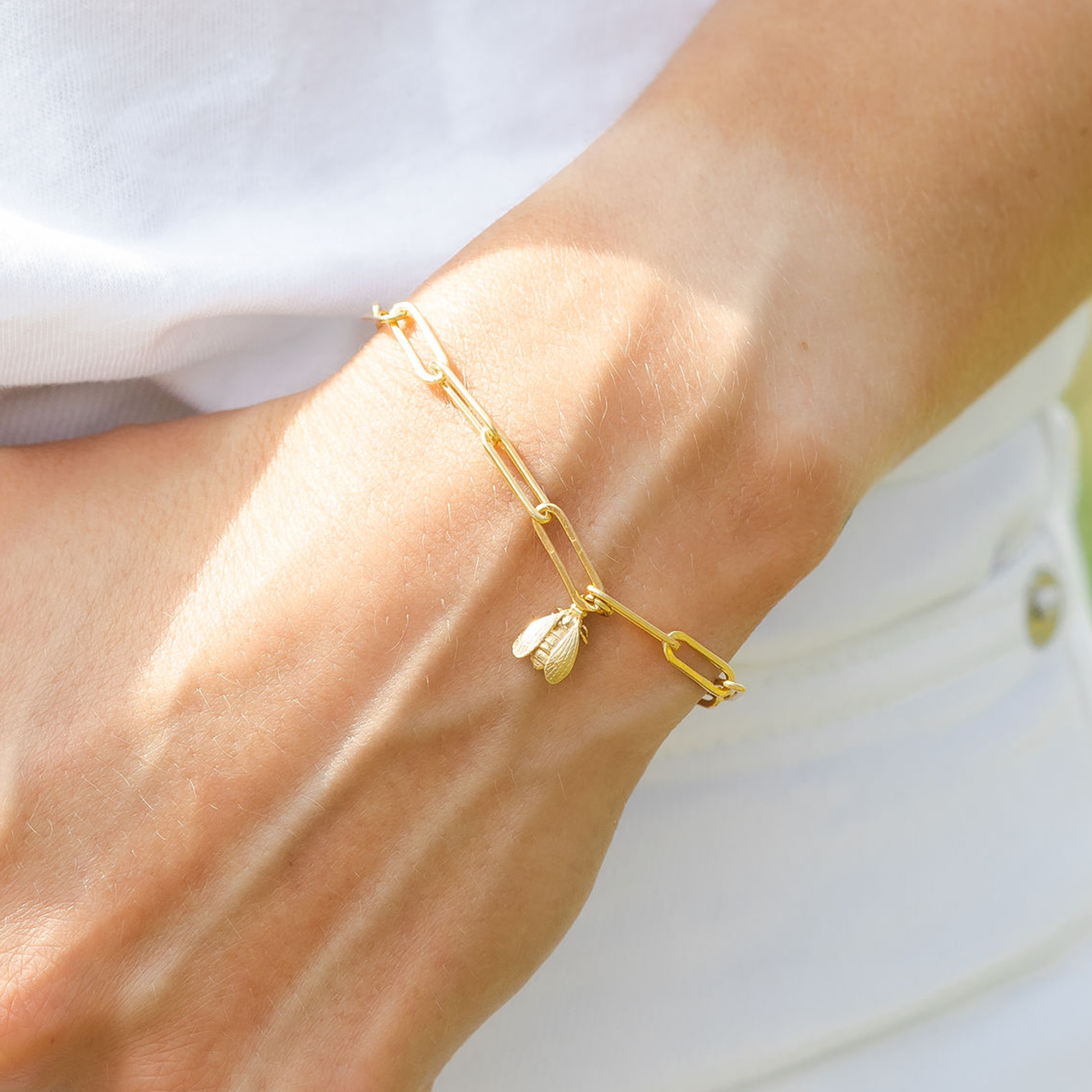woman wearing gold bee bracelet