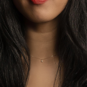 woman wearing gold bee necklace