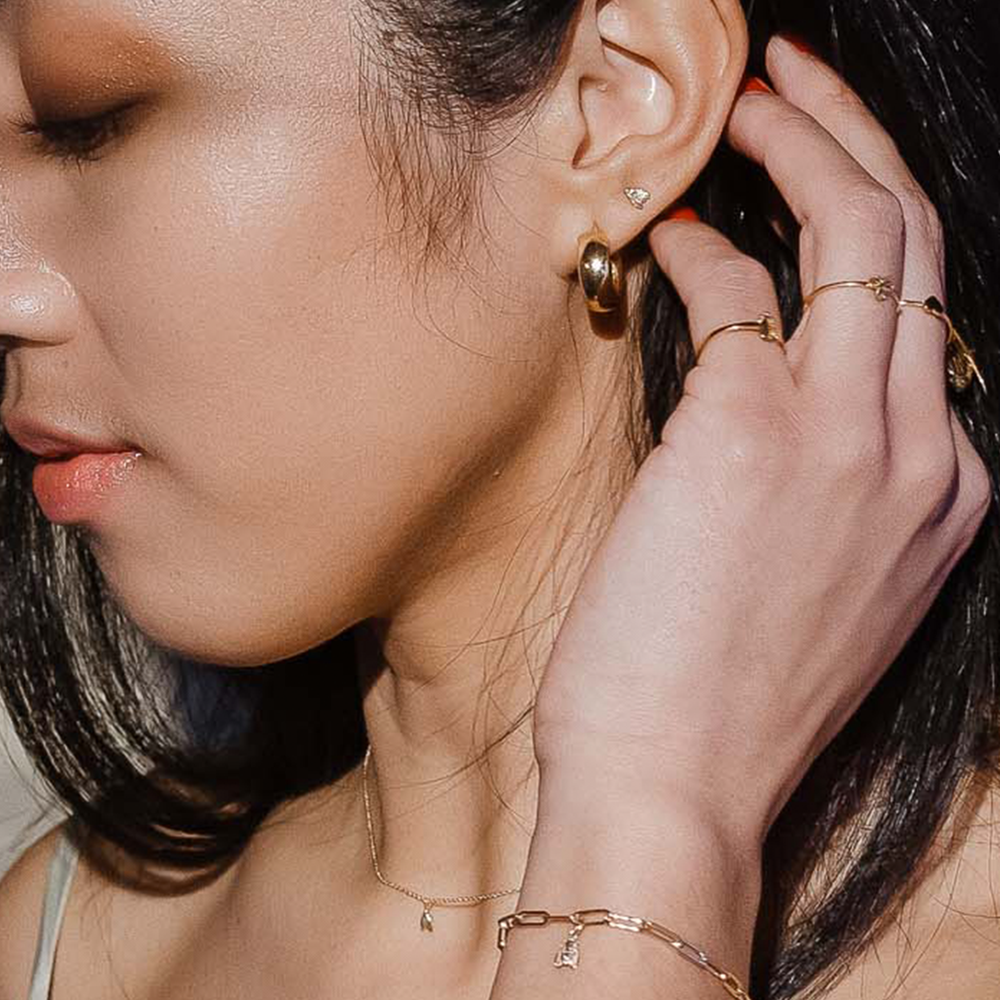 woman wearing gold bee earrings