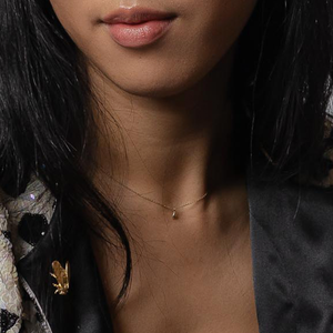 woman wearing gold bee necklace
