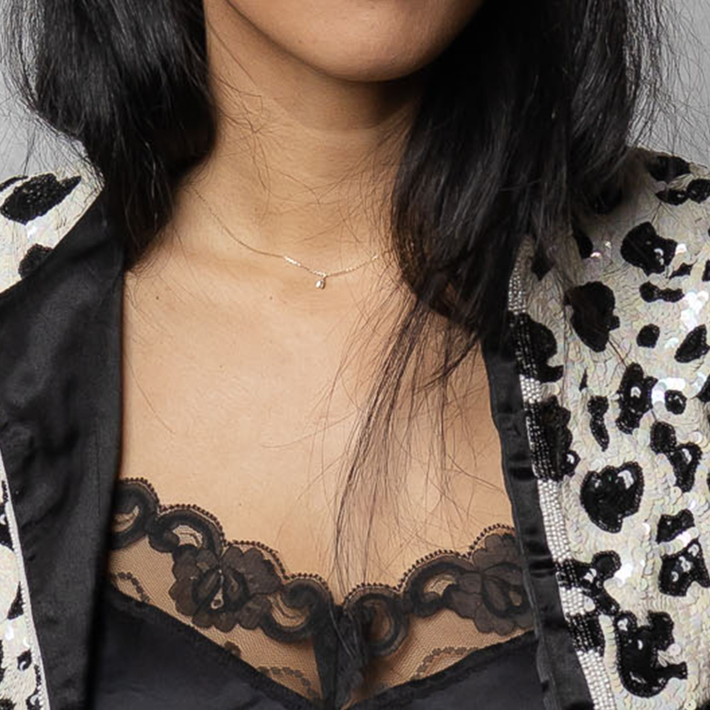 woman wearing gold bee necklace