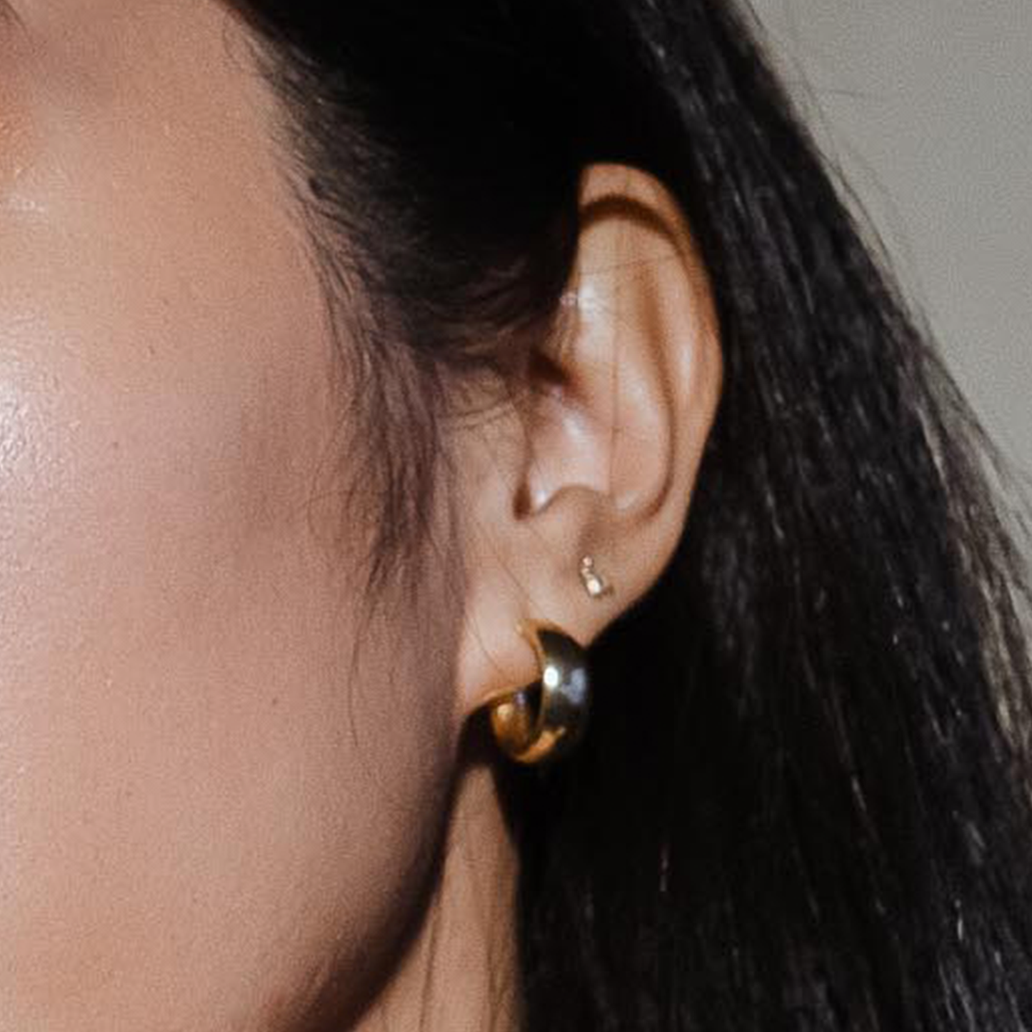 woman wearing gold bee earrings